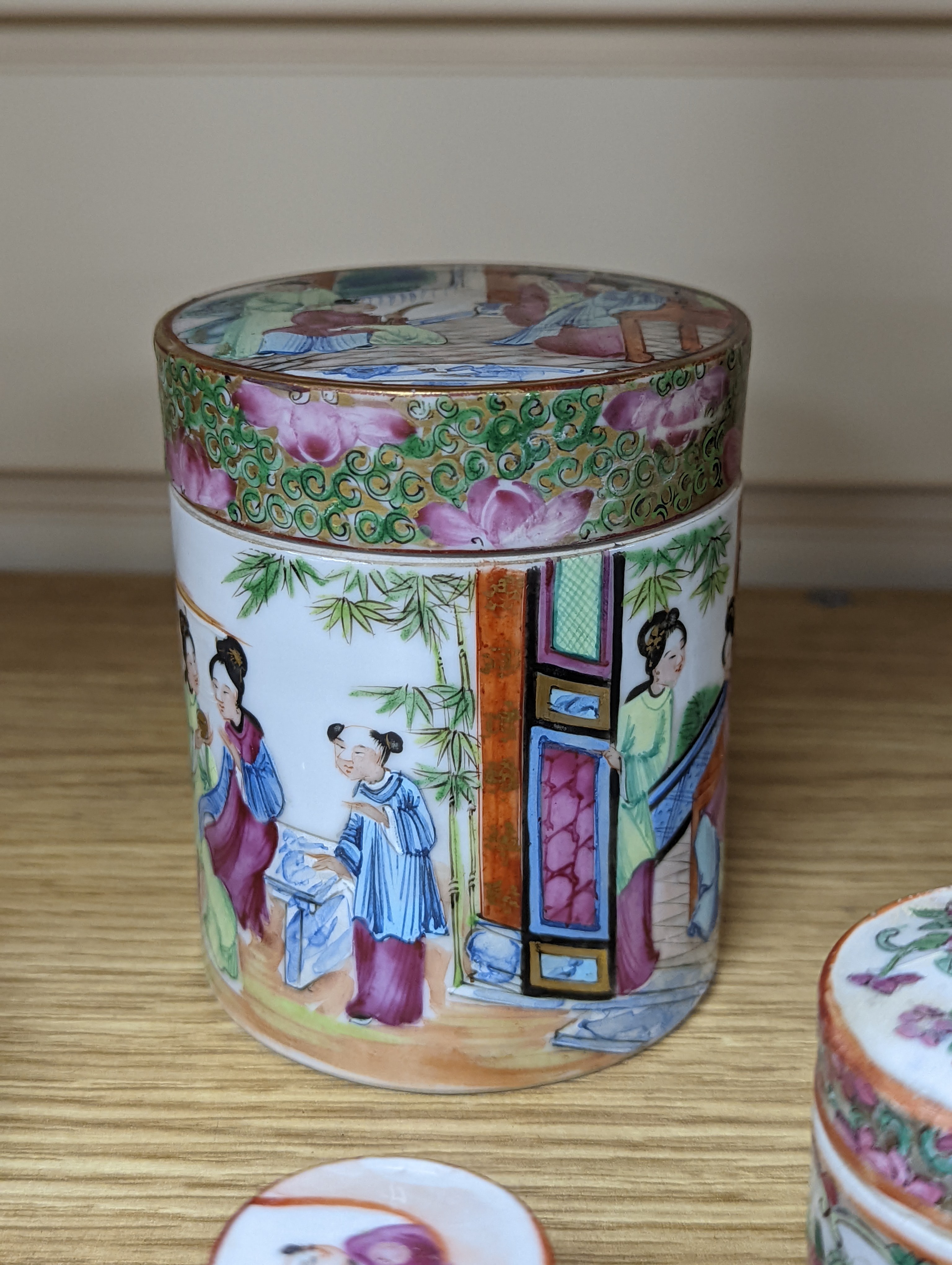 A Chinese Canton famille rose nest of boxes and covers, a similar candlestick and a tray 23cm